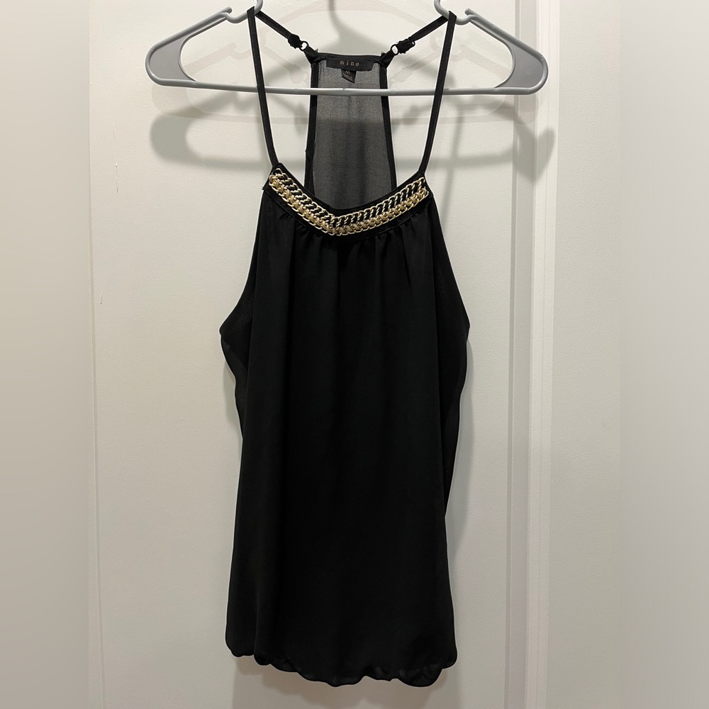 Blouse, top, black with gold, black and white accessory around the neck.